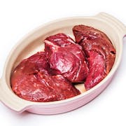 Uncooked kangaroo meat steaks isolated on a white studio background.