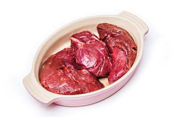 Uncooked kangaroo meat steaks isolated on a white studio background.