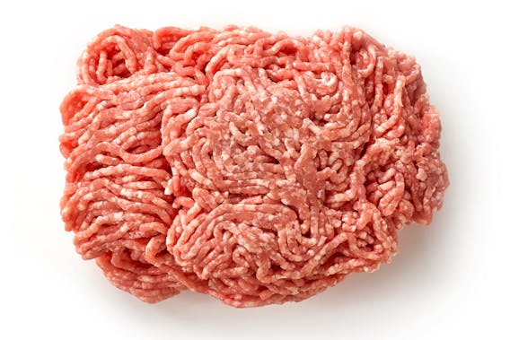 Fresh raw ground pork heap isolated on white background top view
